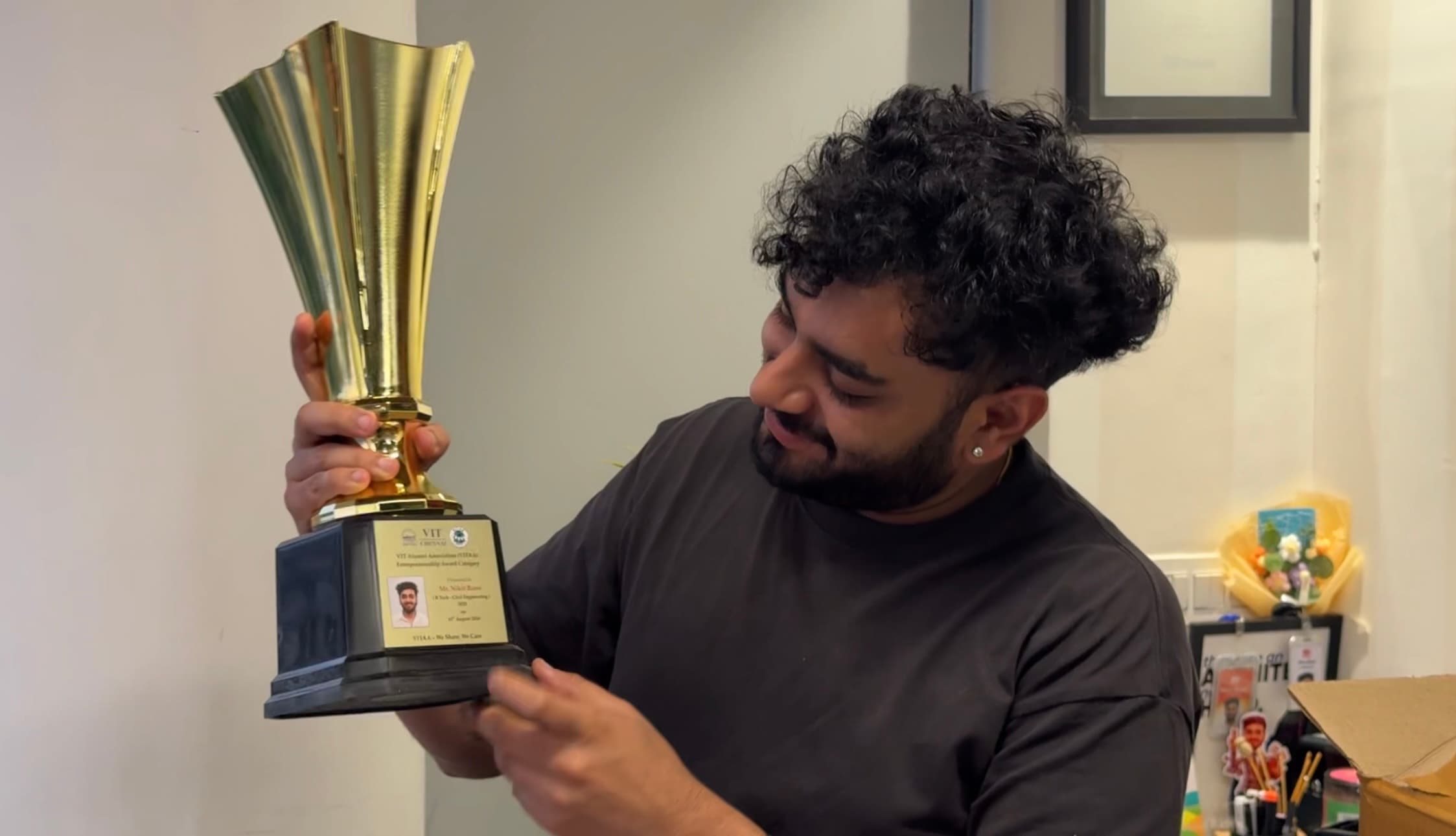A member of the NB Media team holding a trophy